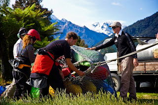 wrangling the massive sling load, notice the snow caped peaks, and the jet fuel tanker in the back ground, NZ, new zealand, chris baer, whereisbaer.com 