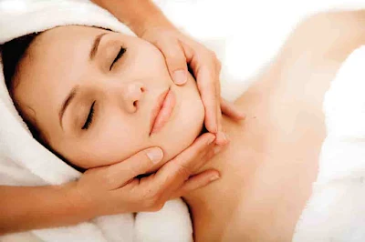 A woman doing face treatment in her clinic