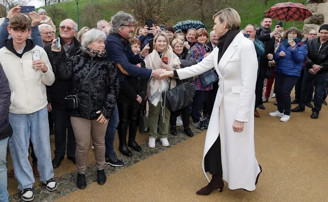 Princess Charlene wore a white wool and cashmere double breasted coat by PAROSH. Haut-Rhin in Alsace. Jeanne de Ferrette