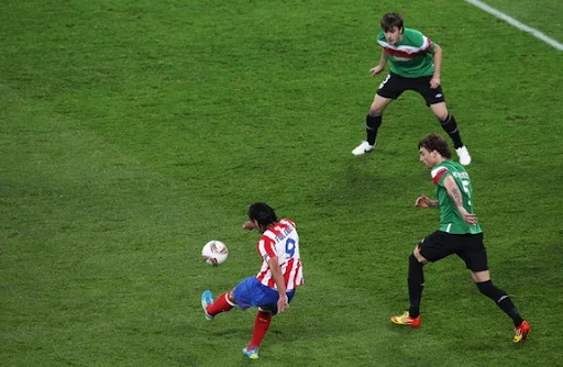 Atlético Madrid striker Radamel Falcao scores against Athletic Bilbao in the Europa League final