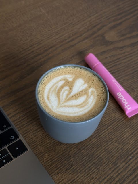 A flat white alongside a Rhode lip peptide tint at Kopenhagen Coffee, Kuala Lumpur