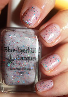 pink nail polish with blue and orange glitter