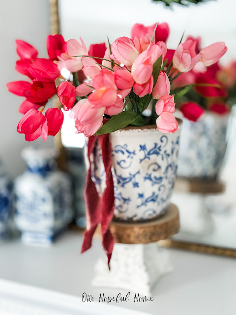 blue white cache pot pink tulips velvet ribbon pedestal riser