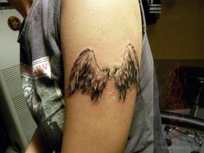 These are actually just two wings of an angel. The artist give this tattoo a 