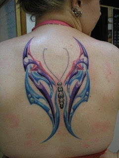Tribal Butterfly tattoo on girls upper back