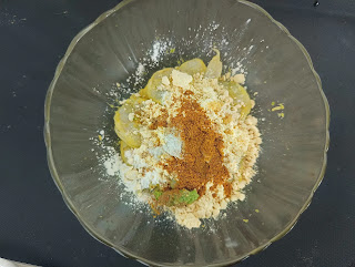 Mixing spices and flour with prawns for prawns koliwada recipe