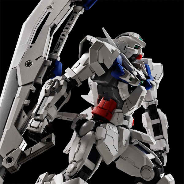 Photograph of the assembled Gundam Astraea robot, seen from behind against a black background.