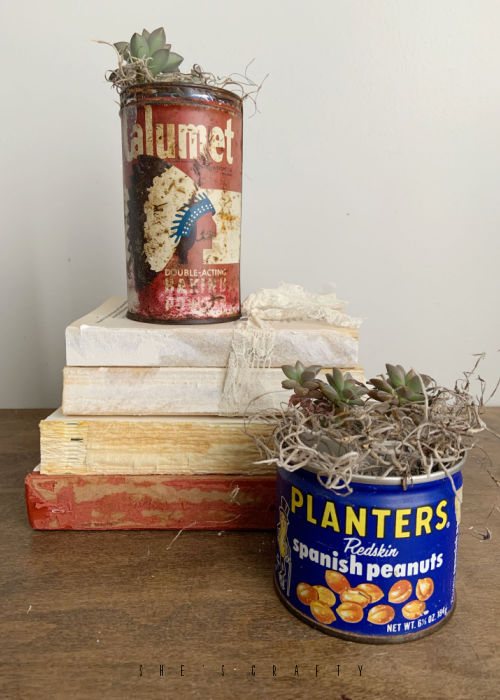 Vintage cans on distressed books.