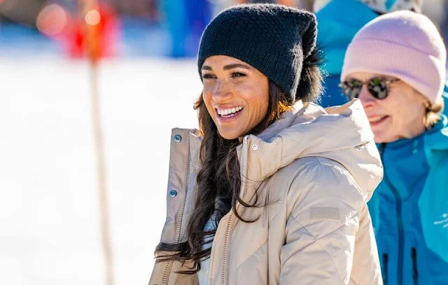 Meghan Markle wore a Barley maxi puffer jacket by Calvin Klein. Sorel Joan arctic boots. Co cashmere crew neck sweater