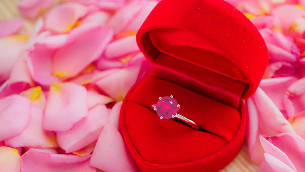 a pink engagement ring in a ring box