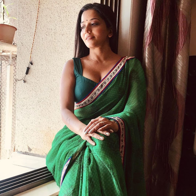 Monalisa stunning in a green saree, exuding elegance and charm.