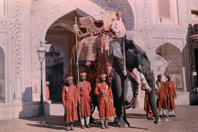 A royal elephant flanked by guards awaits the Maharaja - 1929