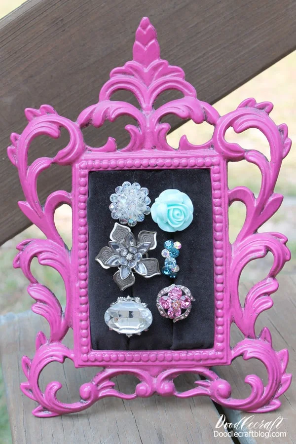 This fabulous tutorial on upcycling vintage Frames into Ring Display cases was done in 2012.    It was posted so long ago, I knew it was time to dust it off and push it out again. Did you see it the first time back in 2012?   If you did, you deserve a medal. 🏅    Gorgeous right?  I just love to see ALL my rings in one place! These cheap cocktail rings double as home decor now!