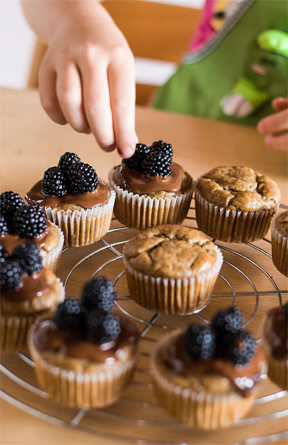 Vegan banana muffins with chocolate and blackberrys finnishing focus