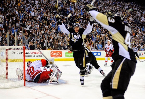 Evgeni-Malkin-71-of-the-Pittsburgh-Penguins-reacts-toward-Philippe-Boucher-43