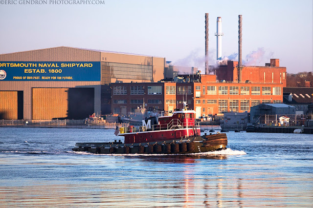 A harbor tugboat at sunrise