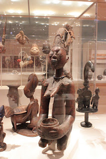 A photograph of a series of large African sculptures carved in wood.