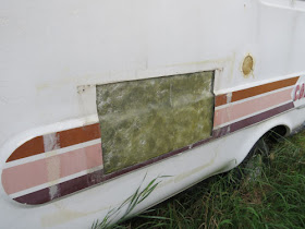 side of a fiberglass trailer with big repaired area