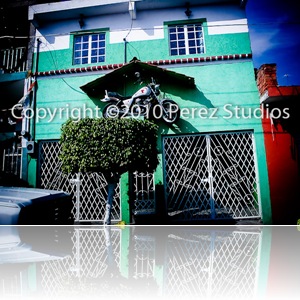 A photo of a motorcycle hanging over a front door of a home in Leon, Guanajuato, Mexico.