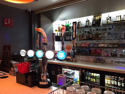 hotel bar with straws, beer pumps, bottles etc