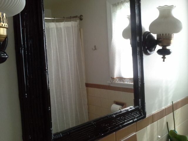 Vintage Bathroom Makeover gold and black light fixture black bamboo mirror