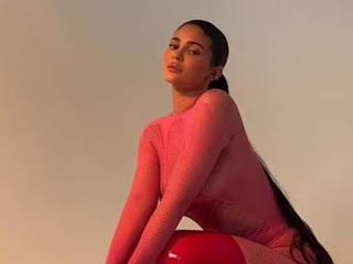 Kylie Jenner Stuns In Pink Mesh Jumpsuit and Red Thigh High Boots At New Photoshoot