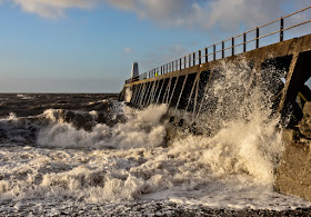 Photo of another view of the waves breaking against the pier