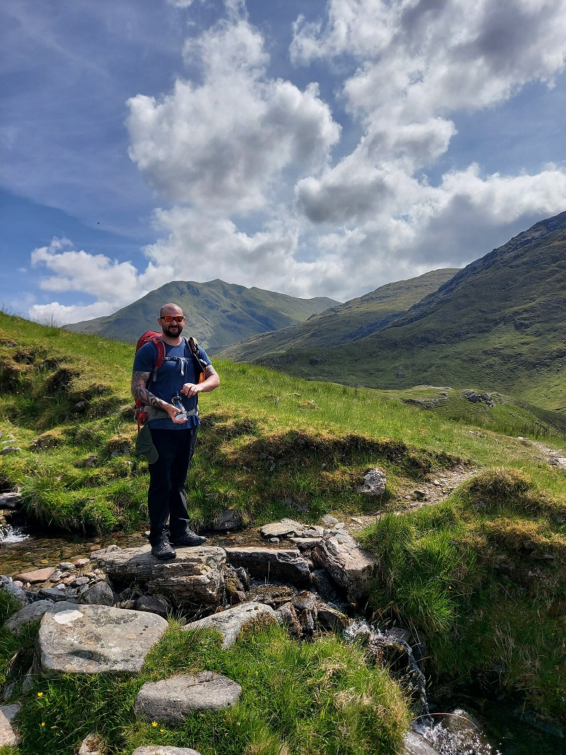 Gordon filling his Water 2 Go bottle from a stream on day 4