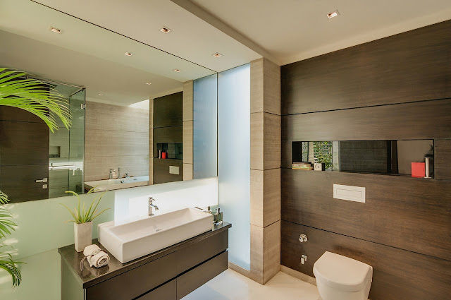 Picture of huge mirror and modern furniture in the bathroom