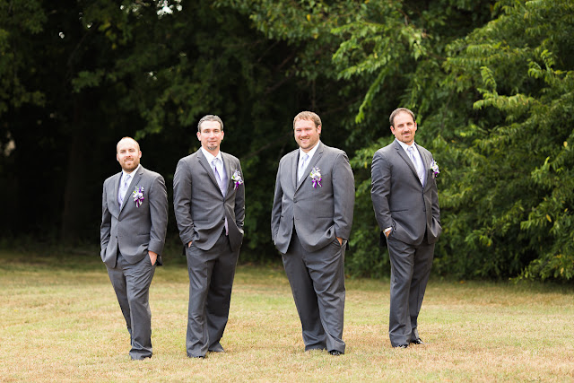 The groom and his groomsmen dressed in gray suits.  They're wearing lavender ties and vests, with white shirts and purple and white corsages, To finish off their ensemble, they're each adorning argyle socks and patent black leather shoes.  Set on the property of the Southern Oklahoma Chinese Baptist Church, located in Norman, OK.