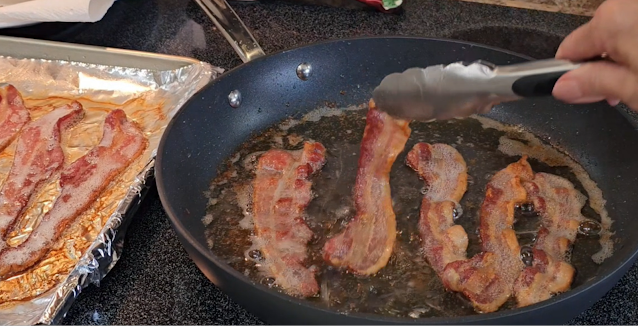 A sheet pan of bacon beside a skillet of bacon.