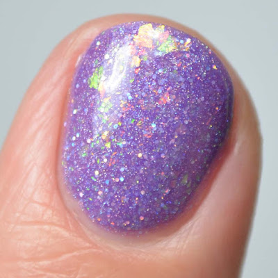 purple nail polish with flakies close up swatch