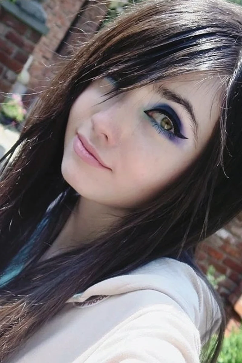 a beautiful portrait of eugenia cooney with side swept bangs and emo makeup