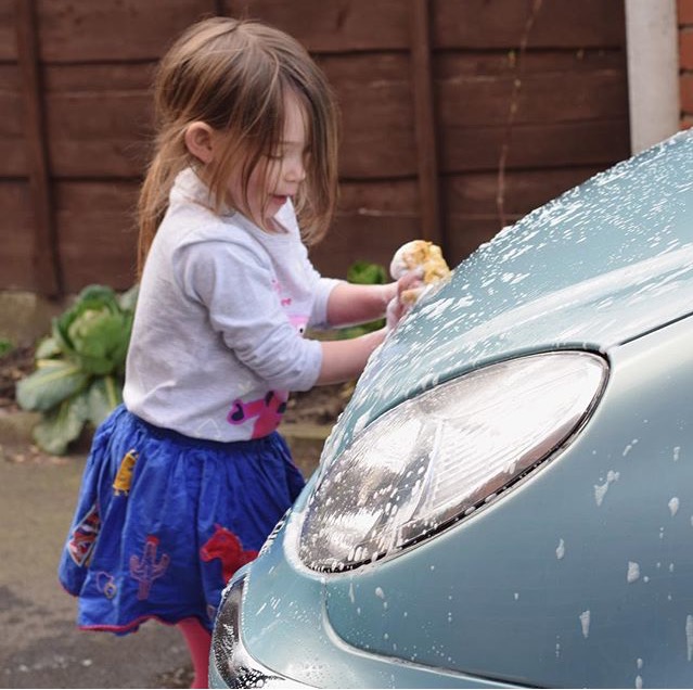 little girl washing car