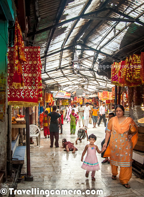 Chintpurni is a place of pilgrimage in Himalayan State of India. Chintpurni is located in Una region of Himachal Pradesh state, surrounded by the western Himalaya in the north and east in the smaller Shiwalik (or Shivalik) range bordering the state of Punjab. Chintpurni is dedicated to the temple of Chinnamastika Devi or Chinnamasta Devi. Chhinnamasta or Chinnamastika temple is one of the 7 major and 51 total Shakti Peeths.This Photo Journey shares some of the photographs from a quick visit to Chintpurni while we were in Amb for an event. During one of the weekends last month, I had to visit Amb in Una for an event. After overnight journey in HRTC Volvo, I reached Amb at around 4:00 am. After taking some rest till 10 am, I had nothing to do as event had to start at 3:00 pm. Chintpurni Temple is 30 Kilometers form Amb and it takes around 1:15 hrs to reach there. So I thought of visiting Chintpurni Temple while it was drizzling outside...Above photograph shows devotees buying flowers at Chintpurni Market..Chintpurni Temple is dedicated to Mata Chintpurni Devi which is located in District Una of Himachal Pradesh. Mata Chintpurni Devi is also known as Mata Shri Chhinnamastika Devi. Devotees have been visiting this Shaktipeeth for centuries to pray at the lotus feet of Mata Shri Chhinnamastika DeviPost summers and during Monsoons, lot of folks from Punjab come to Chintpurni Temple. Many of them come on bicycles and others choose trackters, trucks etc... Many families plan it as a religious trip and some of them also spend holidays in surrounding hill stations like Dharmshala & Palampur.Above photograph shows a Grandmother with her granddaughter, walking towards temple of Mata Chintpurni.Many folks reach temple in this way... This is one of the ways to take blessings of Chintpurni Mata. People lie down, make a mark, get up and again lie down to measure next distance. Whole distance till Temple entry is covered like this only.  It is hard to believe for someone who see it first time, but it's true..Just next to the temple, there is a huge tree which is covered with lot of red colored cloths (Chunnis), Sehra and choodas... Newly married couples come here to present their sehra and chooda(a set of red bangels, especially used by newly married girls in India)... Folks who come to the temple with some wishes, they tie a red colored cloth on branches of this tree. Above photograph shows one of the newly married girl with a Sehra on left and Chooda on right...Lot of devotees from Punjab bring with them their worldly concerns and seek blessings from the Devi. It is believed that if you ask something from the Devi with a true heart, your wish will be granted. Apart from the holy shrine, the place is full of picturesque surroundings. Some very nice places for sight seeing, indoor and out door activities are situated in and around Chintpurni. Chintpurni is very well connected through roads and with good number of hotels... You can come here for religious visit, on a holiday or for both, you would enjoy your time there and should return with everlasting memories Mangoes are found in abundance around Chintpurni and some intersting mango products can be bought from shops in Chintpurni MarketHindu pilgrimage and marriage records were also used to be kept at this holy place. The Genealogical Society (GSU) of Utah, USA has microfilmed Hindu pilgrimage records for Haridwar and several other Hindu pilgrimage centers. Priests (pandits) located at each site would record the name, date, home-town and purpose of visit for each pilgrim. These records were grouped according to family and ancestral home. The holdings by GSU include Haridwar, Kurukshetra, Pehowa, Chintpurni, Jawalapur and JawalamukhDevotees usually bring offerings for the Devi. Sweets, Rice kheer, batasha, coconut, chunni, dhwaja (red-colored flag), flowers and ghee are some of the offerings that devotees bring. Many people still prefer to bring prasad from home, but different kinds of stuff is available in market. Above photograph shows back side of main temple where people sit and prey to the godess.Photography session after mundan Sanskar at Chintpurni Temple, Una, Himachal PradeshMany families come to Chintpurni Temple for Mundan Sanskar where head of children is shaved with some poojan. There is a specific section in Temple campus, where all these Poojan Sanskars are donShehnai Team @ Chintpurni Temple, Una, Himachal Pradesh, INDIA ...In the center of the Temple is the temple garbha griha. The image of Mata Chintpurni Devi is installed here in the form of a round stone. People queue up for a darshan of the Devi and make their prayers and offerings. The view of the Chintpurni town and the far flung scenic contours is enjoyable from the back-yard of the temple.