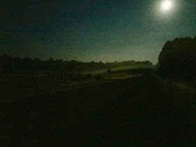 Full August moon on mist-covered fields