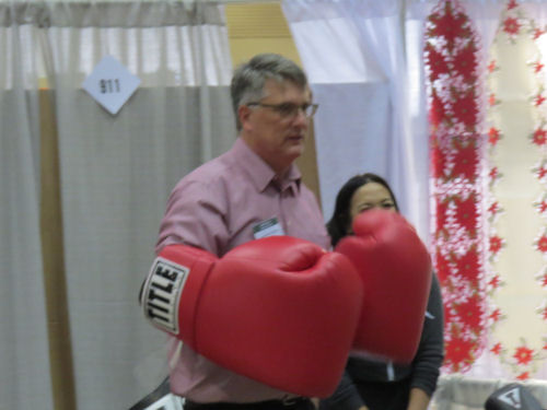 man wearing huge boxing gloves