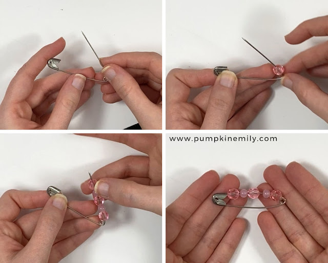Putting beads on a safety pin.