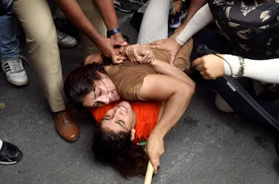 Protesting Indian wrestlers being taken away forcefully by police.