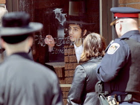 A member of the Lev Tahor ultra-orthodox Jewish sect motions workers with the Chatham-Kent Children's Services to move away from the school near Chatham, Ont., in April 2014.