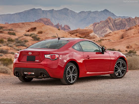 Rear three-quarters view of red 2013 Scion FR-S in desert setting