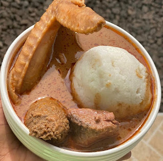 Omotuo with peanut soup and chicken with assorted meat