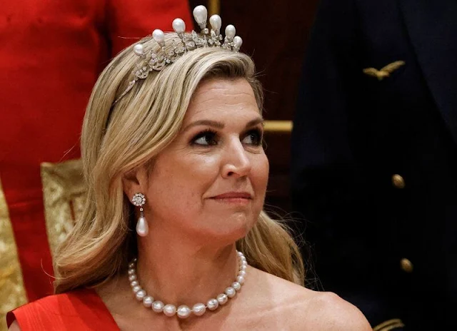 Queen Maxima wore a new red satin dress by Claes Iversen. President Emmanuel Macron and Brigitte Macron