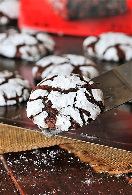 Removing a Brownie Mix Chocolate Crinkle Cookie from the Baking Sheet with a Spatula Image