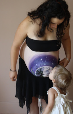 Pregnant woman with stomach painting