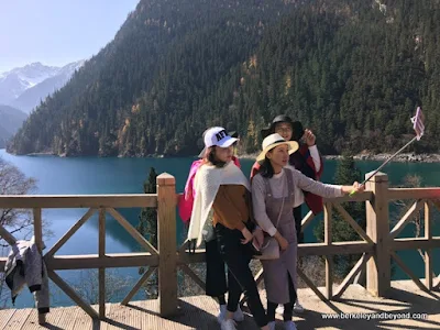 girls take selfie at Long Lake in Jiuzhaigou Valley National Park in Sichuan Province, China