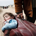 Heartbreaking photo shows a father fleeing war-torn Syria with his son in a suitcase