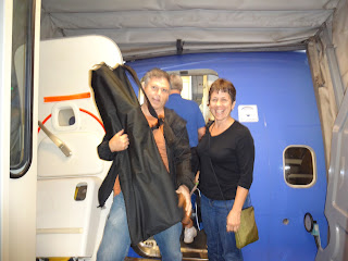 Rocco and Susan in the jetway of a plane.  Rocco is holding a large bag with my prosthetic inside.