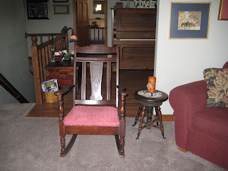 very dark wood with red upholstered seat antique rocking chair