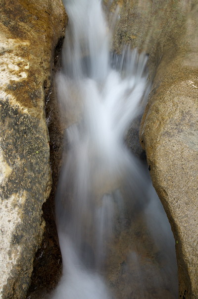 Image of water running through the rocks of the river bed